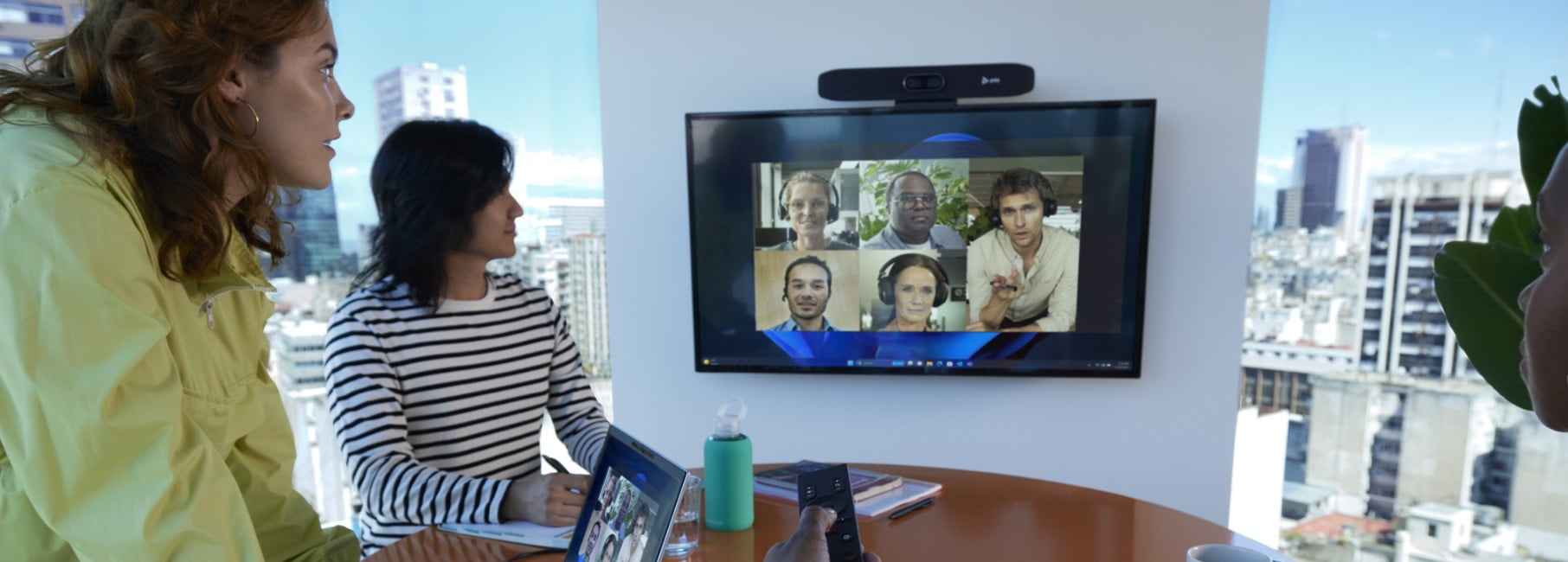 People in a meeting using Poly Studio R30 Plus video conferencing camera